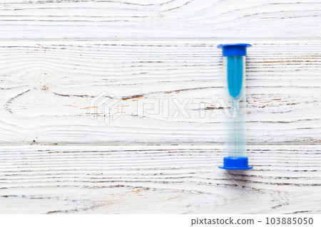 hourglass on the table, sand clock as time passing concept for business deadline, copy space hourglass on the table, sand clock as time passing concept for business deadline, copy space 103885050