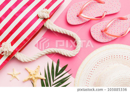 Beach accessories straw hat and seashell on colored table. Summer concept background Beach accessories straw hat and seashell on colored table. Summer concept background 103885336