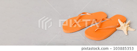 Beach accessories. Flip flops and starfish on colored background. Top view Mock up with copy space 103885353