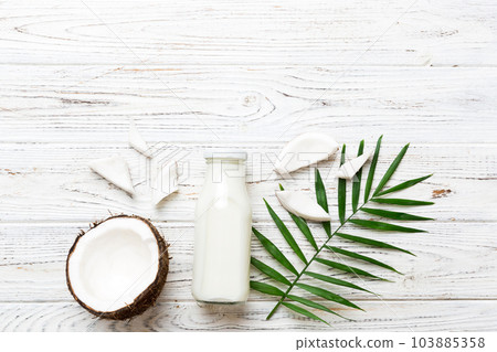 coconut products on white wooden table background. Dairy free milk substitute drink, Flat lay healthy eating coconut products on white wooden table background. Dairy free milk substitute drink, Flat lay healthy eating 103885358