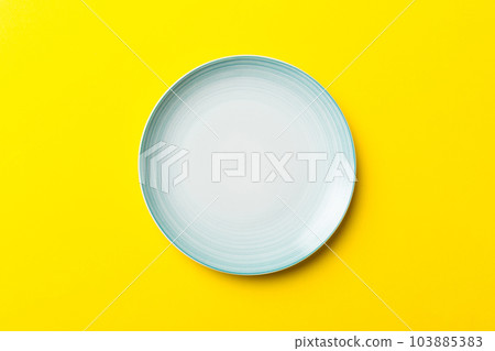 Top view of isolated of colored background empty round blue plate for food. Empty dish with space for your design 103885383