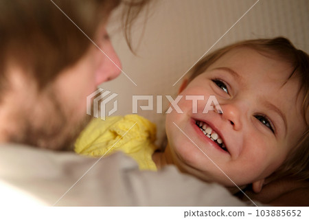 Happy Father with Daughter, Tiny Girl. One Year Baby Smiling, Laughing, Looking up at Daddy. Man Showing Affection to Child. Candid Real Emotion. Beard Dad and Little Kid. Authentic Family Lifestyle. Happy Father with Daughter, Tiny Girl. One Year Baby Smiling, Laughing, Looking up at Daddy. Man Showing Affection to Child. Candid Real Emotion. Beard Dad and Little Kid. Authentic Family Lifestyle. 103885652
