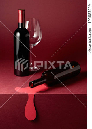 Bottles of red wine and an empty glass on a red background. 103885999