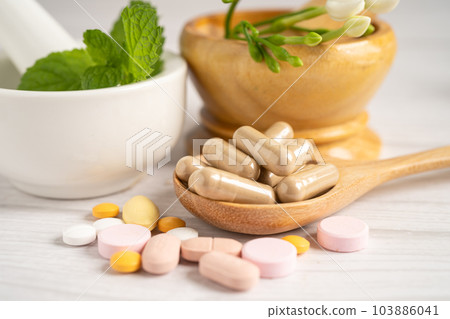 Alternative medicine herbal organic capsule with vitamin E omega 3 fish oil, mineral, drug with herbs leaf natural supplements for healthy good life. Alternative medicine herbal organic capsule with vitamin E omega 3 fish oil, mineral, drug with herbs leaf natural supplements for healthy good life. 103886041