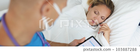 Man physician making prescription for ill woman, examining of patient Man physician making prescription for ill woman, examining of patient 103887288