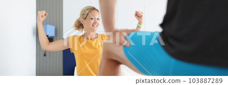 Happy woman showing masculine strength with hands in bed with man 103887289