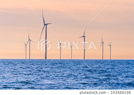 Offshore Windmill farm. windmills isolated at sea on a beautiful bright day Netherlands 103888198