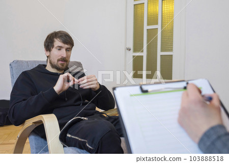 Portrait of a man at a consultation with a psychotherapist, talks about his problems. 103888518