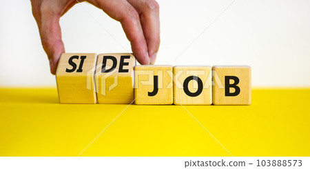 Side job symbol. Businessman turns wooden cubes and changes concept words Job to Side job. Beautiful yellow table white background, copy space. Business side job concept. Side job symbol. Businessman turns wooden cubes and changes concept words Job to Side job. Beautiful yellow table white background, copy space. Business side job concept. 103888573