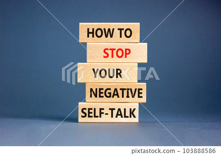 Stop negative self-talk symbol. Concept words How to stop your negative self-talk on wooden block. Beautiful grey table grey background. Psychological negative self-talk concept. Copy space Stop negative self-talk symbol. Concept words How to stop your negative self-talk on wooden block. Beautiful grey table grey background. Psychological negative self-talk concept. Copy space 103888586