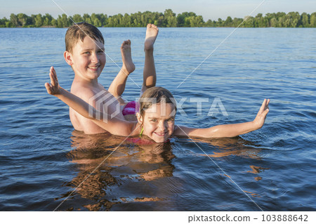 Happy children play in the water. Summer vacation, active lifestyle 103888642
