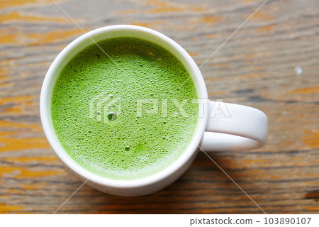 Cup of freshly made matcha tea on table  103890107