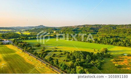 Panoramic landscape of Bohemian Paradise at sunrise time on sunny day. With Trosky castle ruins and Hruba Skala castle and sandstone rocks, Czech Republic. Aerial view from drone. 103891180