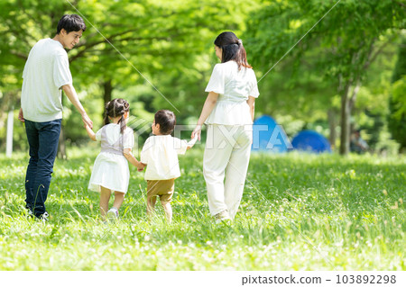 A family walking hand in hand 103892298