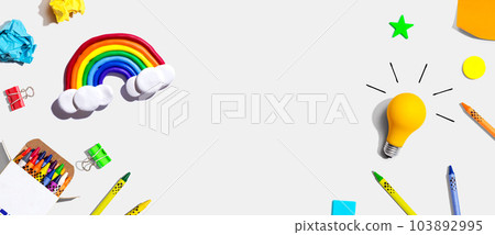 Idea light bulb with a rainbow and school supplies - flat lay 103892995