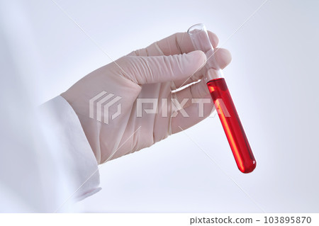 Test tube with blood in the hand. Test tube with blood in the hand. 103895870