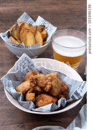 Fried chicken, potatoes and beer Vertical position 103896196