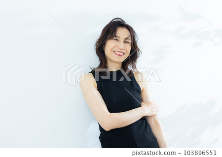 Female in her 50s, black sleeveless 103896551