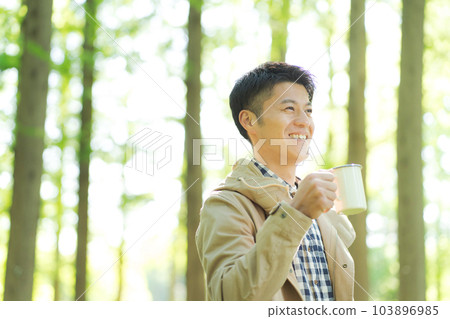 Woman drinking coffee in nature 103896985