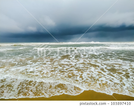 clear white wave on the beach against the stormy sky clear white wave on the beach against the stormy sky 103897410