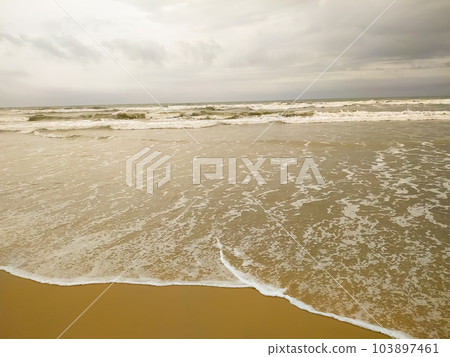 Summer beach concept - Soft wave of sea on empty sandy beach Background 103897461