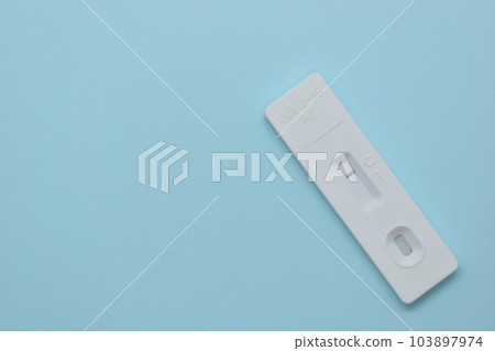 covid test kit on blue background covid test kit on blue background 103897974
