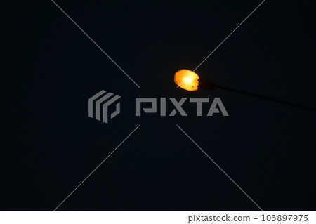 warm orange light in the night, black sky background warm orange light in the night, black sky background 103897975