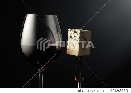 Glass of red wine and blue cheese. 103898283