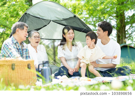 Three generation family enjoying camping Three generation family enjoying camping 103898656