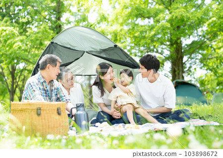 Three generation family enjoying camping 103898672