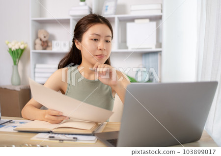 Young Asian female student watching teacher's live performance or video call on laptop in classroom at home, Conversations with teachers and classmates, Online learning, Study at your own home. 103899017