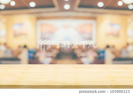 Empty wood table top with cafe restaurant interior blurred background 103900123