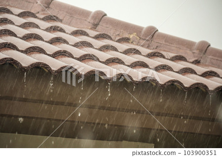 rain falling down from the house roof rain falling down from the house roof 103900351