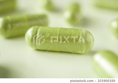 Herbal medicine capsules on white background 103900389
