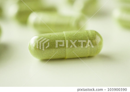 Herbal medicine capsules on white background Herbal medicine capsules on white background 103900390