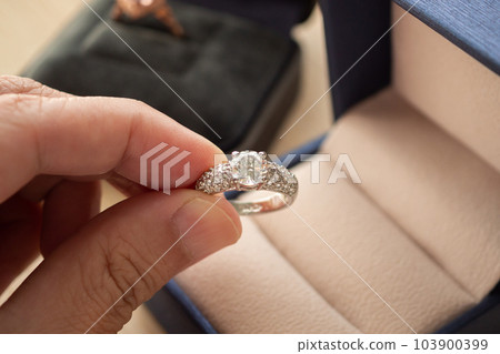 hand hold beautiful jewelry diamond ring hand hold beautiful jewelry diamond ring 103900399
