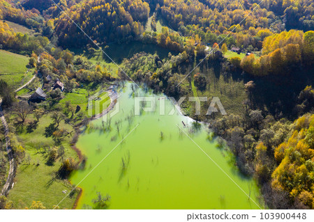 Aerial view of green mine waters from a copper mine flooding natural habitat Aerial view of green mine waters from a copper mine flooding natural habitat 103900448