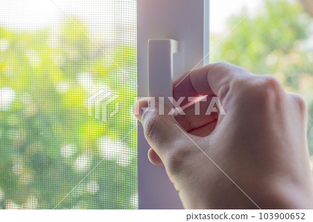 Hand hold mosquito net wire screen handle on house window Hand hold mosquito net wire screen handle on house window 103900652