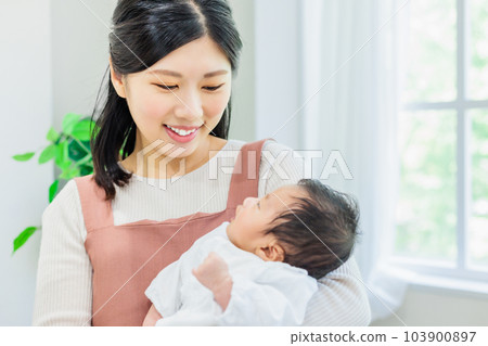 Mother holding a baby 103900897