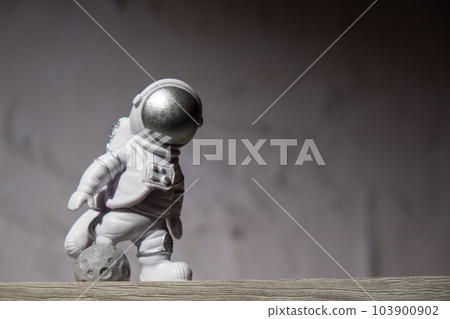 Plastic toy figure astronaut on moon concrete background Copy space. Concept of out of earth travel, private spaceman commercial flights missions and Sustainability Plastic toy figure astronaut on moon concrete background Copy space. Concept of out of earth travel, private spaceman commercial flights missions and Sustainability 103900902
