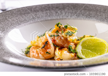 Grilled shrimps with fresh green herbs, lemon and garlic Grilled shrimps with fresh green herbs, lemon and garlic 103901190