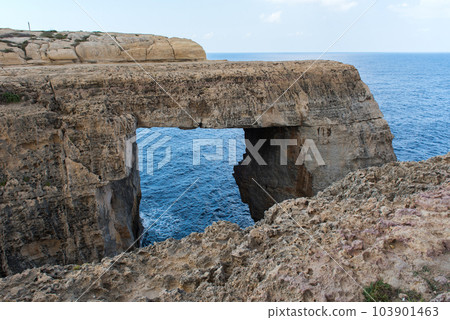 Wied il Mielah canyon, natural arch over the sea. Gozo, Malta 103901463