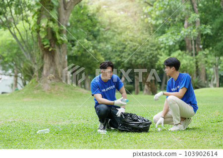 Young Asian Volunteers with garbage bags cleaning park area. Ecology, Charitable organization concept 103902614