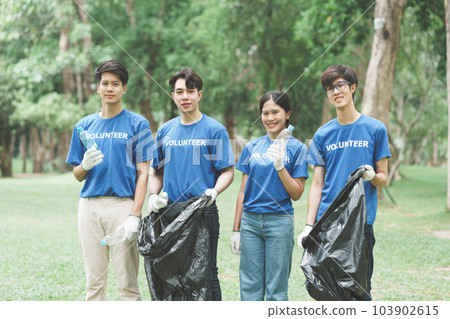 Young Asian Volunteers with garbage bags cleaning park area. Ecology, Charitable organization concept Young Asian Volunteers with garbage bags cleaning park area. Ecology, Charitable organization concept 103902615