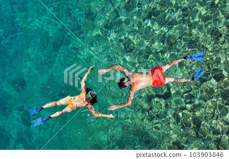 Romantic couple snorkeling in the sea Romantic couple snorkeling in the sea 103903846