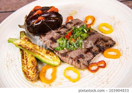 Grilled steak with chimichurri sauce and vegetables 103904833