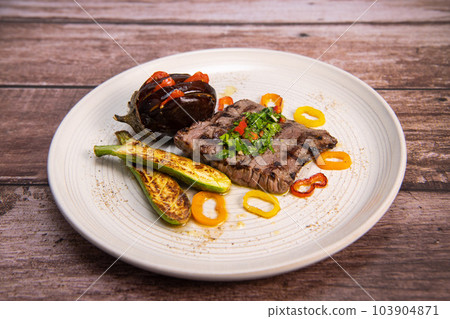 Grilled steak with chimichurri sauce and vegetables 103904871