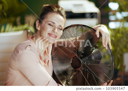 smiling modern accountant woman in modern green office 103905547