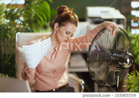 woman worker in green office suffer from heat woman worker in green office suffer from heat 103905559