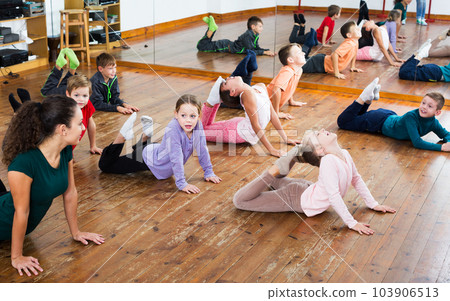 Children exercising in dance hall 103906513